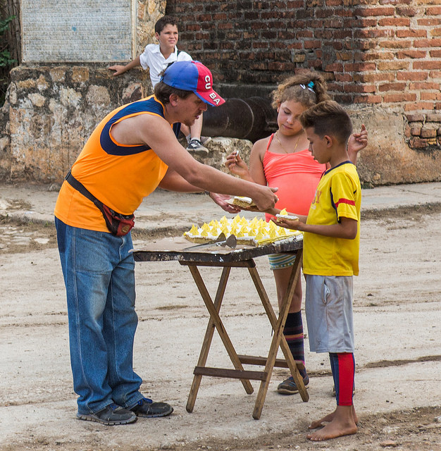 A food vendor sells dessert on the streets of Trinidad.