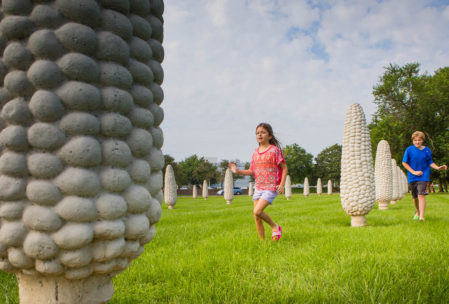Kids run among the giant concrete corn cobs in Frantz Park in Dublin, Ohio.