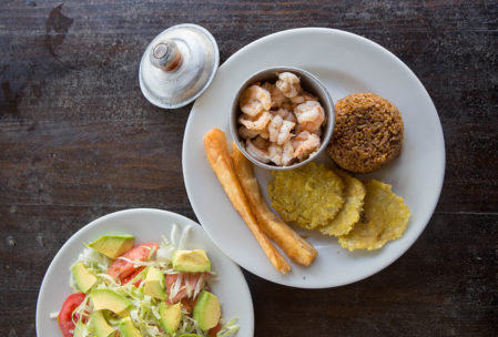 Shrimp with coconut rice, tostones, yucca and avocado salad.