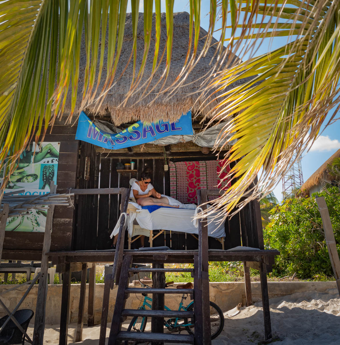A woman gets a massage in a hut on the beach in Puerto Morelos, Mexico.