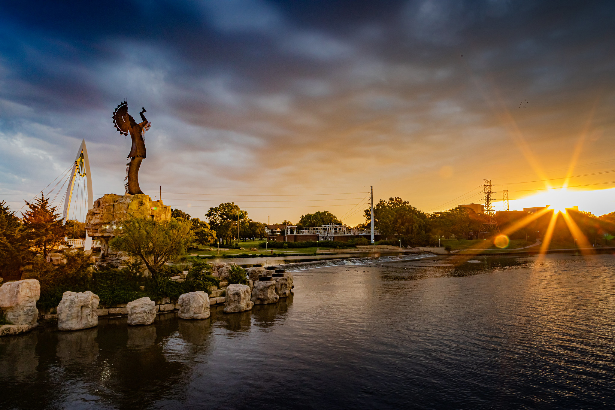 The Keeper of the Plains, a sculpture by Blackbear Bosin, stands over the confluence of the Arkansas and Little Arkansas rivers at dawn. It’s located in the heart of Wichita, Kansas, a jewel in the central plains.