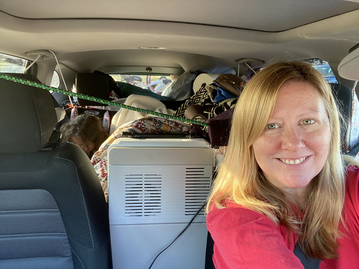 There's a kid in there somewhere! Believe it or not, we had everything organized the way we wanted. The snacks are front and center, followed by soft pillows and blankets. The camping gear and clothing is in the boot.